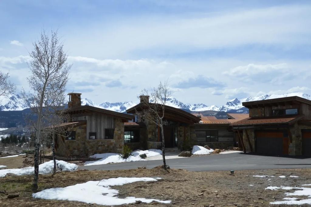 Modern mountain home with snow peaks