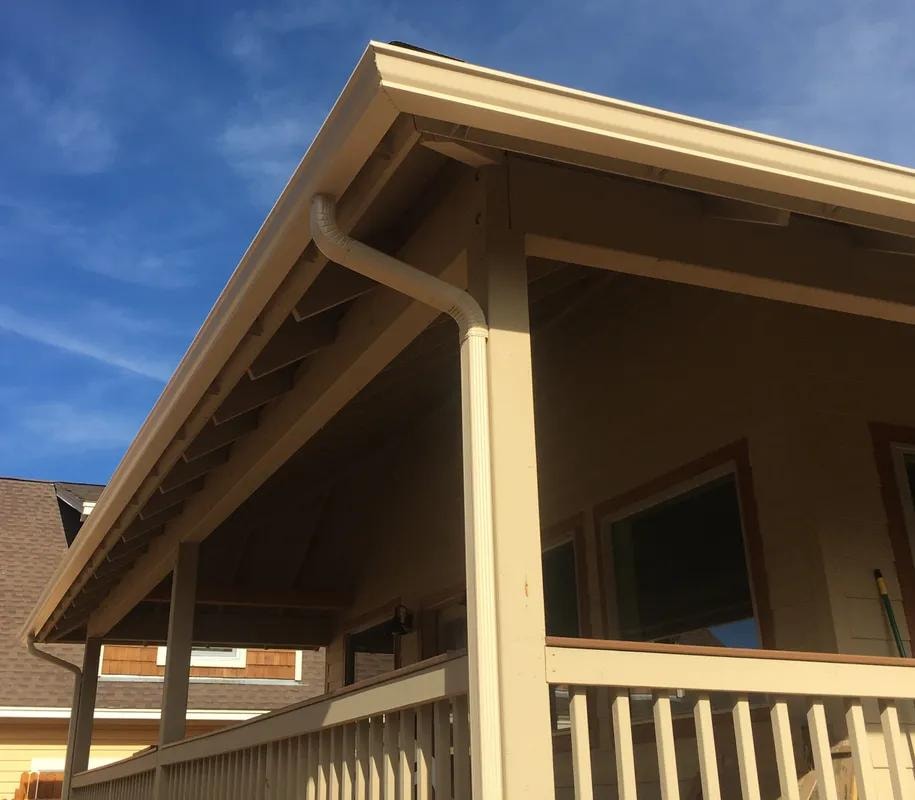 Residential porch with seamless gutters and downspout