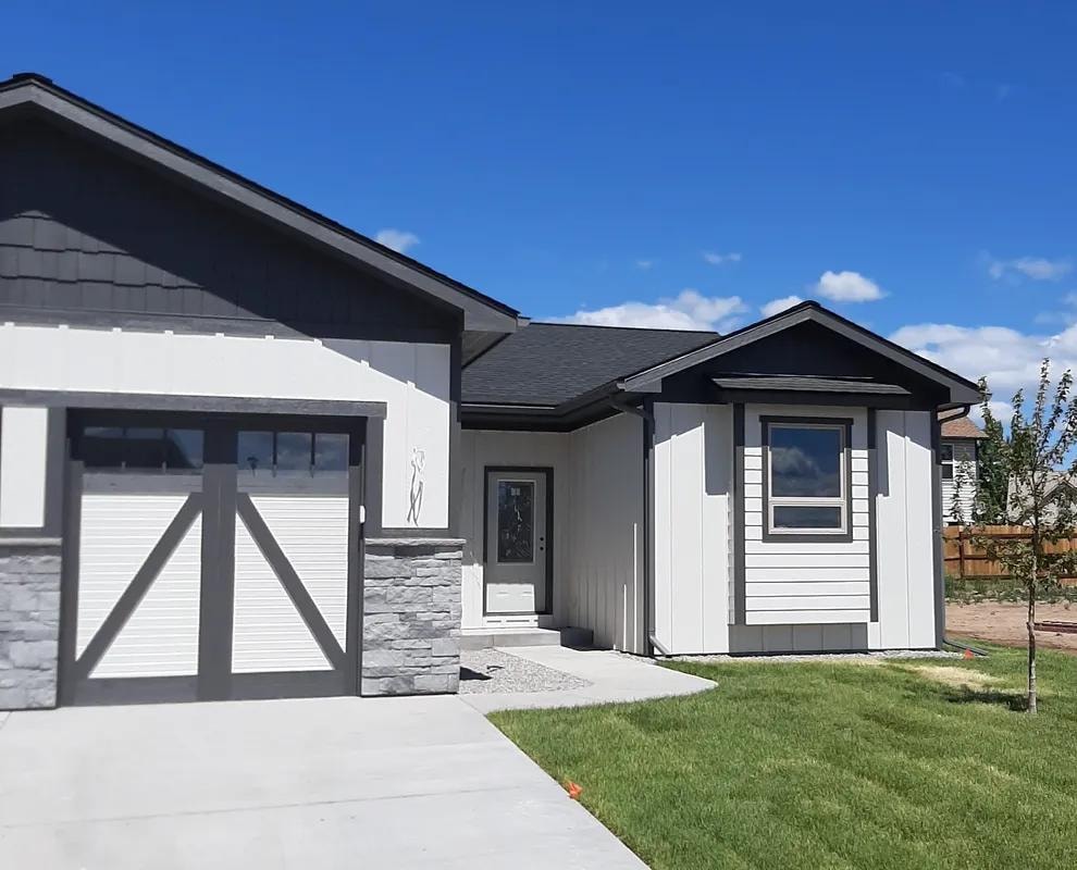 Modern white home with dark gutters